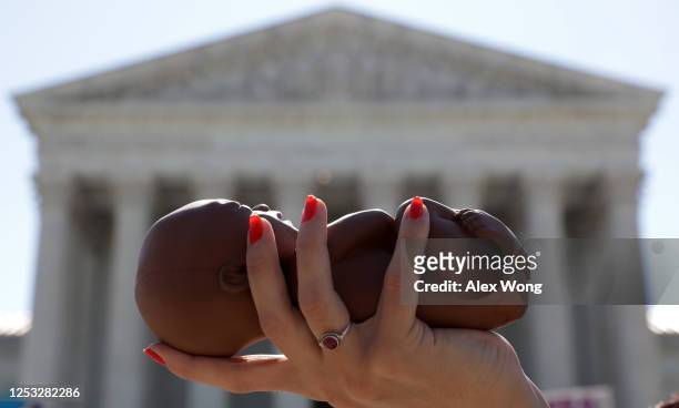 Pro-life activist holds a model fetus during a demonstration in front of the U.S. Supreme Court June 29, 2020 in Washington, DC. The Supreme Court...