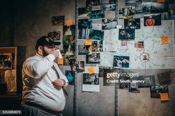 young male detective working on a case in the office - chief technology officer stock pictures, royalty-free photos & images