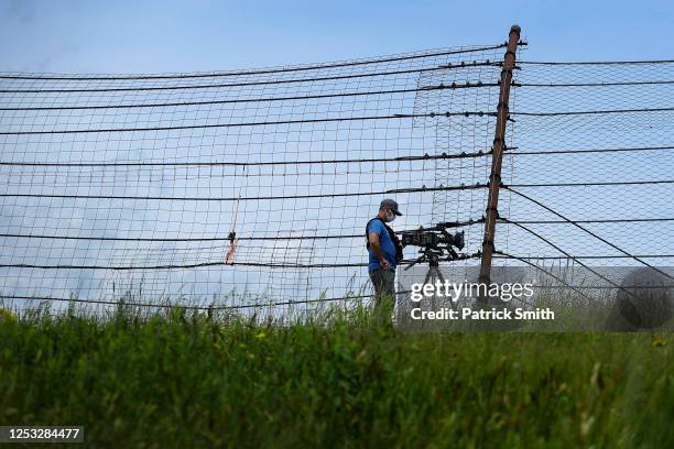 Videographer wears a face covering as he photographs the NASCAR Xfinity Series Pocono Green 225 Recycled by J.P. Mascaro & Sons at Pocono Raceway on...