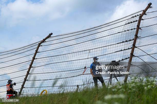 Videographer and photographer wear face covers and properly social distance as they photograph the NASCAR Xfinity Series Pocono Green 225 Recycled by...