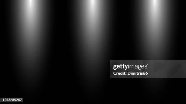 three spotlights on dark background - spotlight film stock illustrations