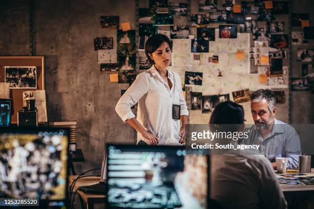 three detectives working on a murder case in the office - chief technology officer stock pictures, royalty-free photos & images
