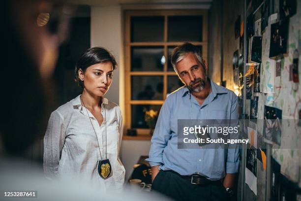 detectives working on a case in the office - female fbi stock pictures, royalty-free photos & images
