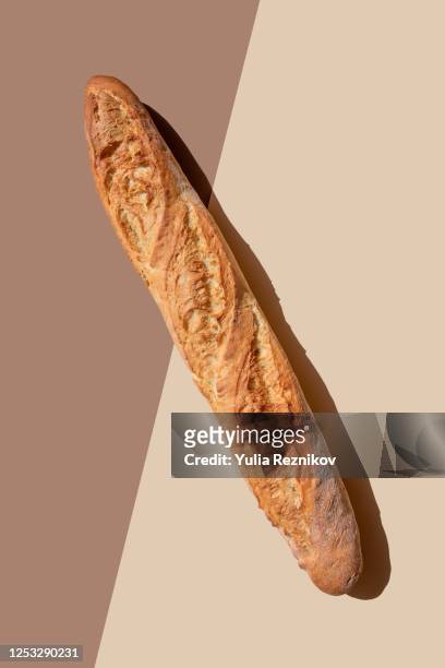 bread baguette on the beige-brown background - french baguette stock-fotos und bilder