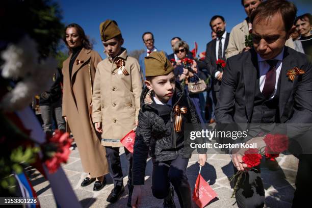 Visitors lays flowers at a statue of a Soviet soldier at the Soviet World War II memorial at Treptower Park on Russia's Victory Day, which marks the...