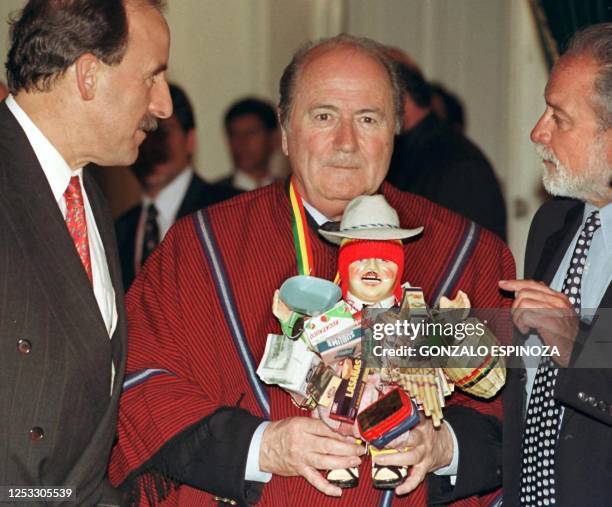 Joseph Blatter, president of FIFA wears typical Bolivian dress while he holds "Ekeko" God of Abundance in his hands in the Aymara language while Luis...