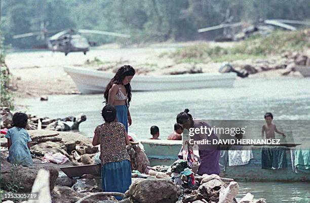 Native Tzeltales women from the Amatitlan community in Chiapas wash clothes and bathe near the Mexican Airforce's Blackhawk helicopters on 07 August...