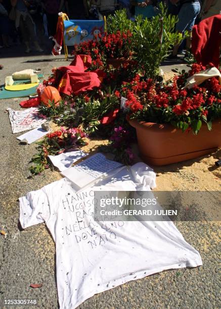 Tee-shirt saying "You have killed a boy on the square where I was born" is laid 21 July 2001 on the spot where Italian activist Carlo Giuliani was...