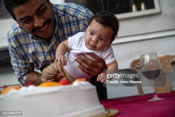 Marvin holds his son Neysel, 10 weeks, at a dinner celebrating Neysel's three month birthday on June 28, 2020 in Stamford, Connecticut. The...