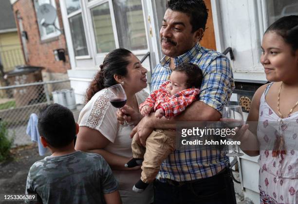 Zully speaks with her husband Marvin and son Neysel, 10 weeks, at a dinner celebrating Neysel's three month birthday on June 28, 2020 in Stamford,...