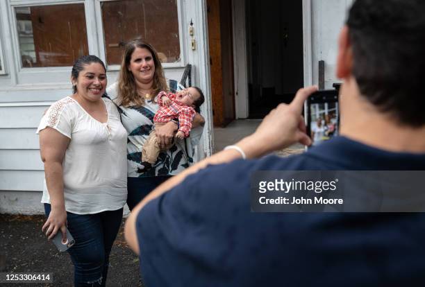 Zully , poses for photos with elementary school teacher Luciana Lira and Zully's son Neysel, 10 weeks, at a dinner celebrating Neysel's three month...