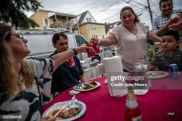 Zully , toasts with elementary school teacher Luciana Lira at a dinner celebrating baby Neysel's three month birthday on June 28, 2020 in Stamford,...