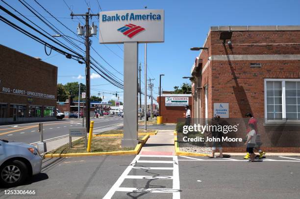 Zully walks to the bank for her first withdrawal with her husband Marvin and sons Junior and Neysel, 10 weeks, on June 25, 2020 in Stamford,...