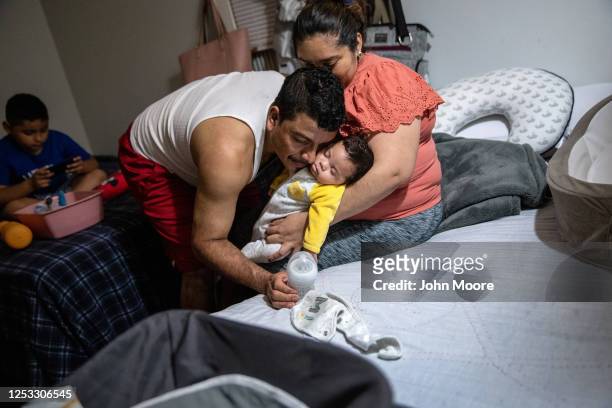 Marvin embraces his son Neysel, 10 weeks, on June 17, 2020 in Stamford, Connecticut. Marvin, his wife Zully , and their son Junior survived Covid-19...