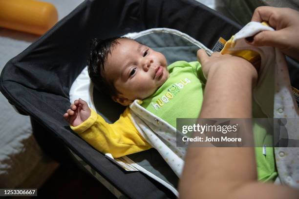 Zully prepares her son Neysel, 10 weeks, for bed on June 17, 2020 in Stamford, Connecticut. On April 1 Zully, then almost 8 months pregnant, was...