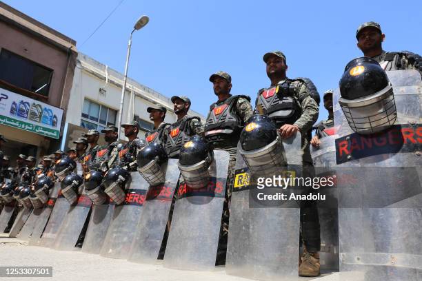 Pakistani security forces are seen outside the Islamabad High Court where former Prime Minister and Chairman of Pakistan Tehreeke-Insaf Imran Khan...
