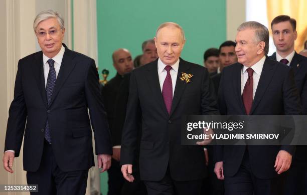 Russian President Vladimir Putin and the leaders of the Commonwealth of Independent States walk to hold a working breakfast after the Victory Day...