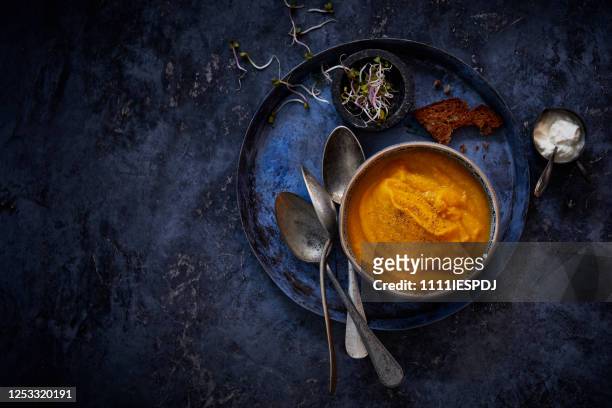 pumpkin soup on a plate - royal blue stock pictures, royalty-free photos & images