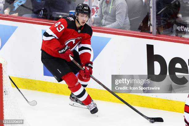 New Jersey Devils defenseman Luke Hughes skates with the puck during Game 3 of an Eastern Conference Second Round playoff game between the Carolina...