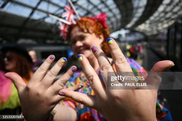 Eurovision super-fan displays their painted nails as they arrive at Lime Street Station in Liverpool, northern England on May 9 ahead of the first...