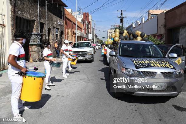 People play Batucada rhythm as graduates parade in their cars during graduation from the 'Instituto de Aprendizaje Creativo' on June 29, 2020 in...