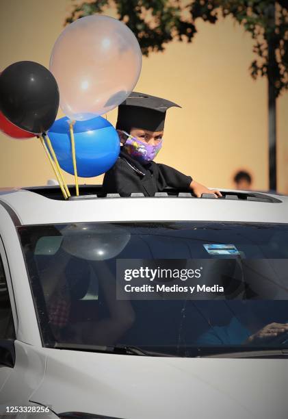 Graduate with a face mask looks on during graduation from the 'Instituto de Aprendizaje Creativo' on June 29, 2020 in Monterrey, Mexico.