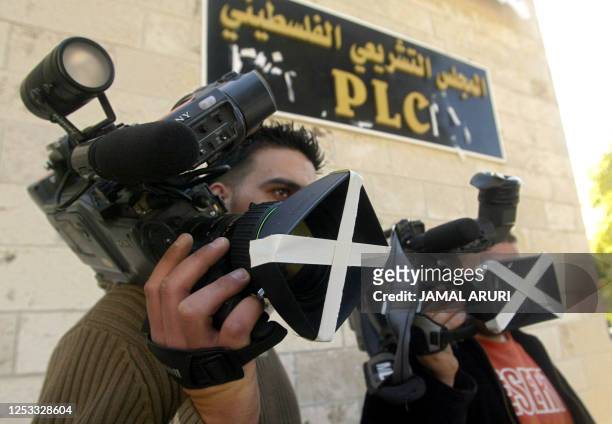 Palestinian journalists hold their tapped video cameras on the third day of a strike against the kidnapping of BBC reporter Alan Johnston during a...
