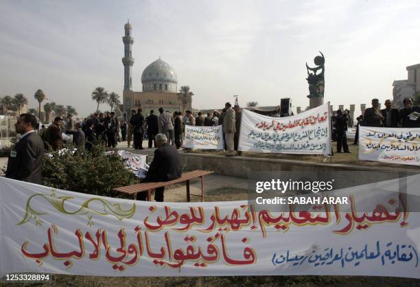 Iraqi teachers hold banners as they demonstrate at al-Firdos Square in central Baghdad, 16 December 2007. Teachers in Iraq with the exception of...