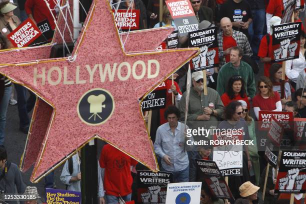 Thousands of striking movie and television writers are joined by supporters from other unions as they march along Hollywood Boulevard 20 November...