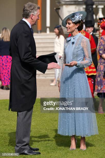 Britain's Catherine, Princess of Wales talks with a guest during a Garden Party at Buckingham Palace in London on May 9 as part of the Coronation...