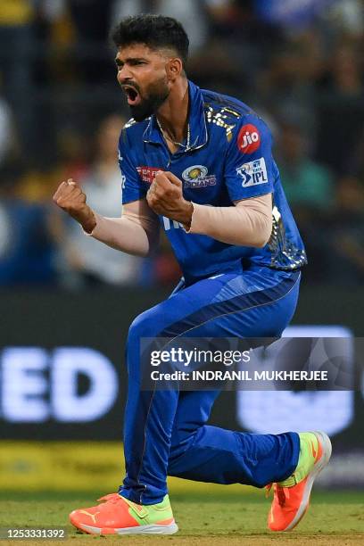 Mumbai Indians' Kumar Kartikeya celebrates after taking the wicket of Royal Challengers Bangalore's Mahipal Lomror during the Indian Premier League...