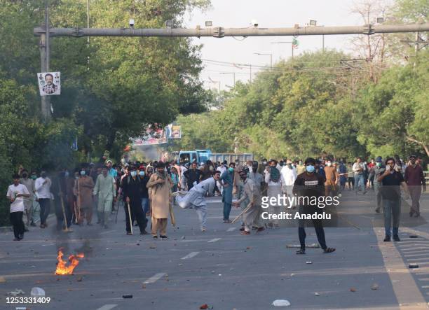 Supporters of Former Prime Minister Imran Khan and political party Pakistan Tehreek-e-Insaf throw stones at the police during a protest held against...