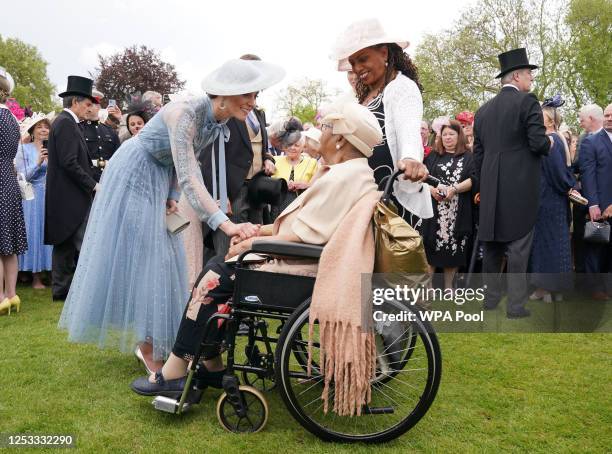 Catherine, Princess of Wales speaks to Aldith Grandison and daughter Jay Cee La Bouche during a Garden Party at a celebration of the coronation at...