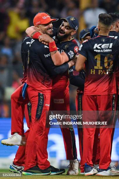 Royal Challengers Bangalore's Virat Kohli celebrates with Faf du Plessis after the dismissal of Mumbai Indians' Rohit Sharma during the Indian...