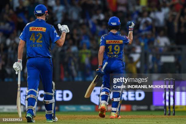 Mumbai Indians' Nehal Wadhera and Cameron Green celebrate after winning the Indian Premier League Twenty20 cricket match between Mumbai Indians and...