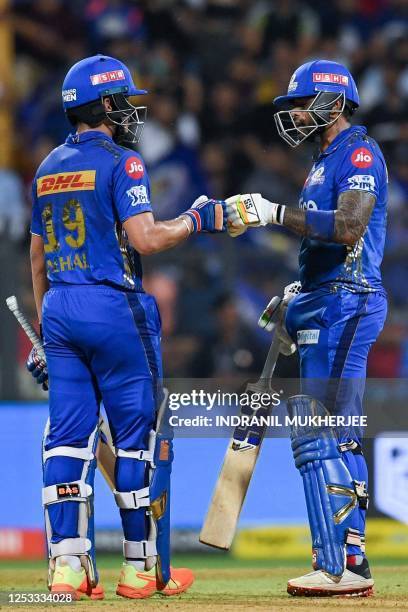 Mumbai Indians' Suryakumar Yadav and Nehal Wadhera bump their fists during the Indian Premier League Twenty20 cricket match between Mumbai Indians...