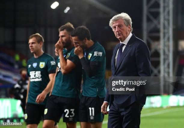 Dwight McNeil, Erik Pieters and Matej Vydra of Burnley celebrate victory together as they walk off in front of Roy Hodgson, Manager of Crystal Palace...