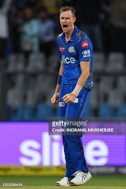 Mumbai Indians' Jason Behrendorff celebrates after taking the wicket of Royal Challengers Bangalore's Anuj Rawat during the Indian Premier League...