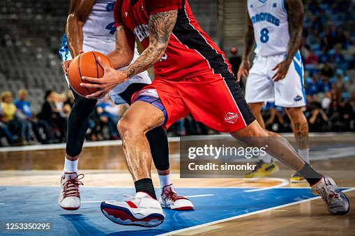 Basketball players tackling for ball Basketball players tackling for ball