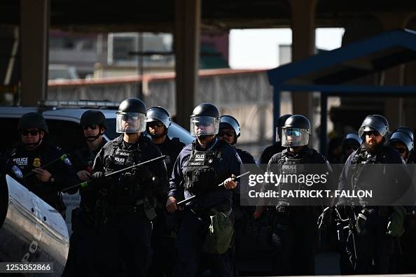 US Customs and Border Protection agents in riot gear participate in ...