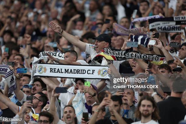 Real Madrid's supporters cheer during the UEFA Champions League semi-final first leg football match between Real Madrid CF and Manchester City at the...