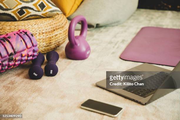 exercise equipments, laptop laying on the floor - net sports equipment foto e immagini stock