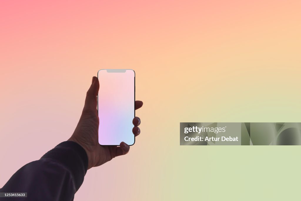 Creative picture capturing the colors of sunset sky with mobile phone.