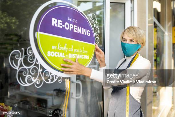 covid-19. open sign in a small business shop after coronavirus pandemic - retail covid stock pictures, royalty-free photos & images