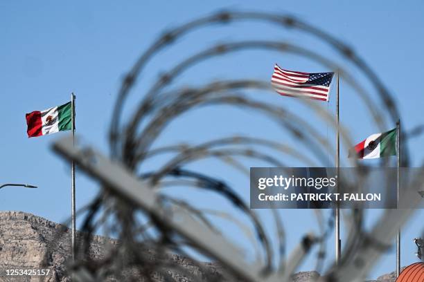 The flags of the United States and Mexico blow in the wind near US Customs and Border Protection Border Patrol Paso del Norte Port of Entry on the...
