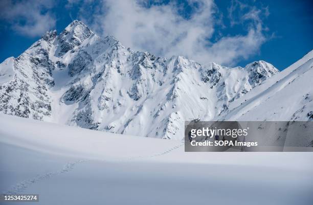 Trekkers walk on a snow covered mountain at an elevation of 3725 m Infront of Katsal Peak at Sorus Lake in South Kashmir. The mesmerising Sorus Lake...