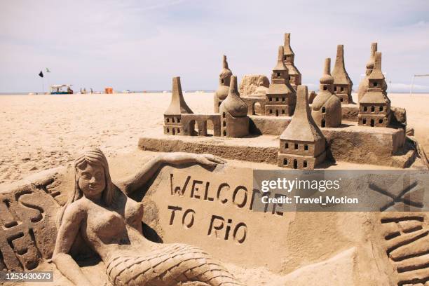 welcome to rio sand castle on copacabana beach in rio de janeiro - sand sculpture stock pictures, royalty-free photos & images