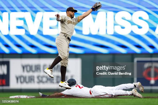 Michael A. Taylor of the Minnesota Twins steals second base against Xander Bogaerts of the San Diego Padres in the third inning at Target Field on...