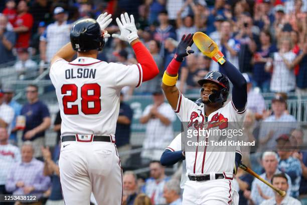 Matt Olson of the Atlanta Braves reacts with Ronald Acuna Jr. #13 after hitting a two run home run during the first inning against the Boston Red Sox...