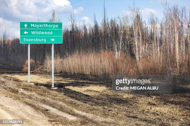 Sign just off Highway 16 is pictured surrounded by burnt grass and trees in the Yellowhead County area, Alberta, Canada on May 9, 2023. Canada...